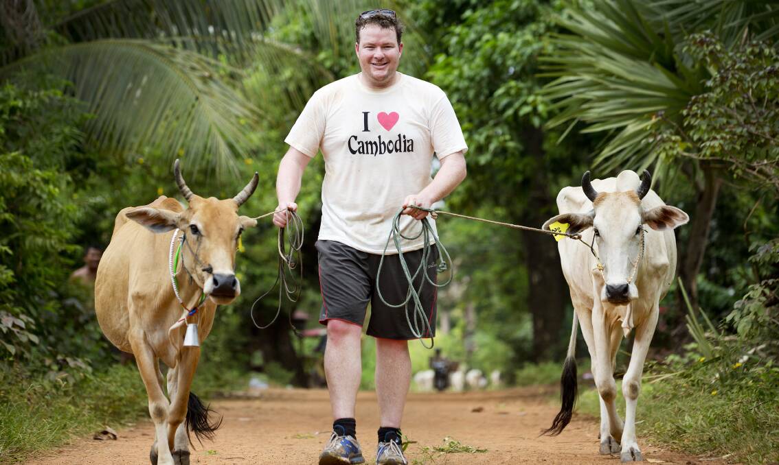 Cows for Cambodia founder Andrew Costello with two of the breeders in the charity. PHOTO: Cows for Cambodia.