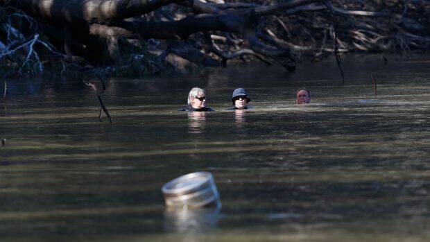Divers search for the five-year-old boy who was later found dead in the river. Photo: Luke Hemer