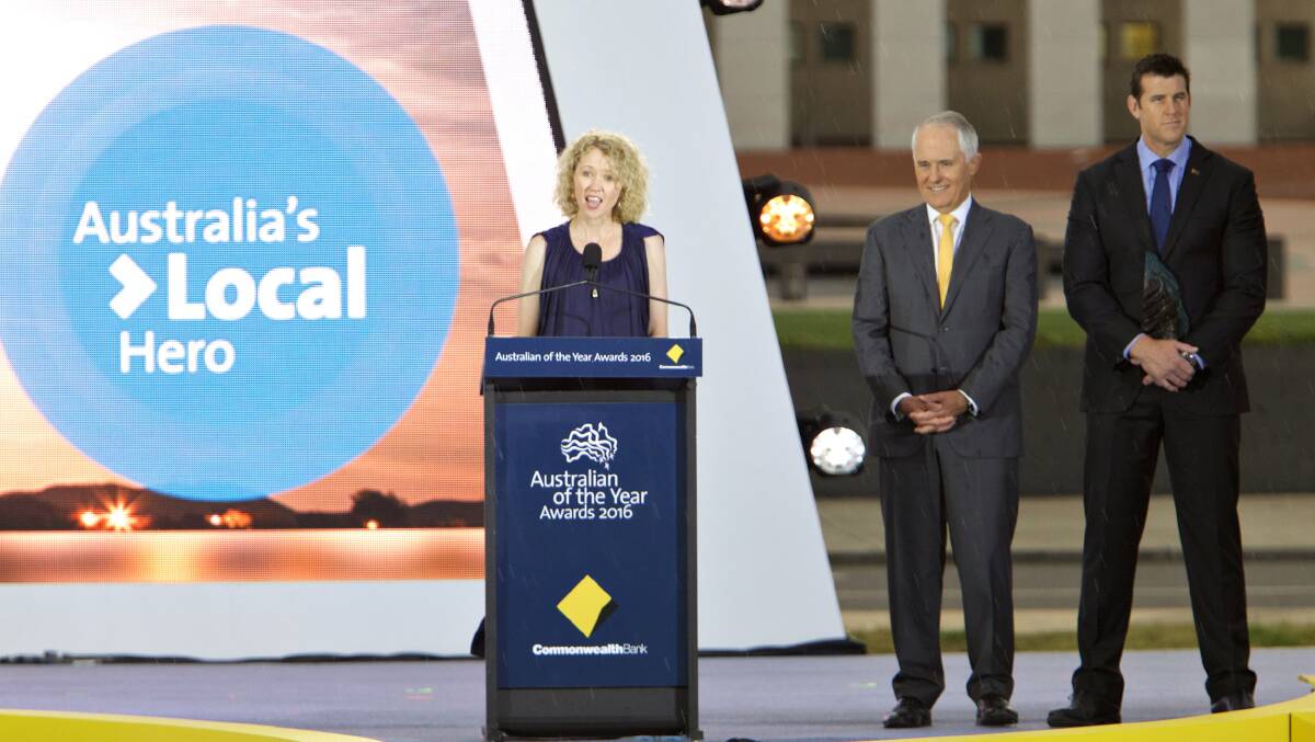 Catherine Keenan takes to the stage in Canberra on January 25, 2105. Behind her are Prime Minister Malcolm Turnbull and the National Australia Day Council chairman Ben Roberts-Smith . Pic: NADC