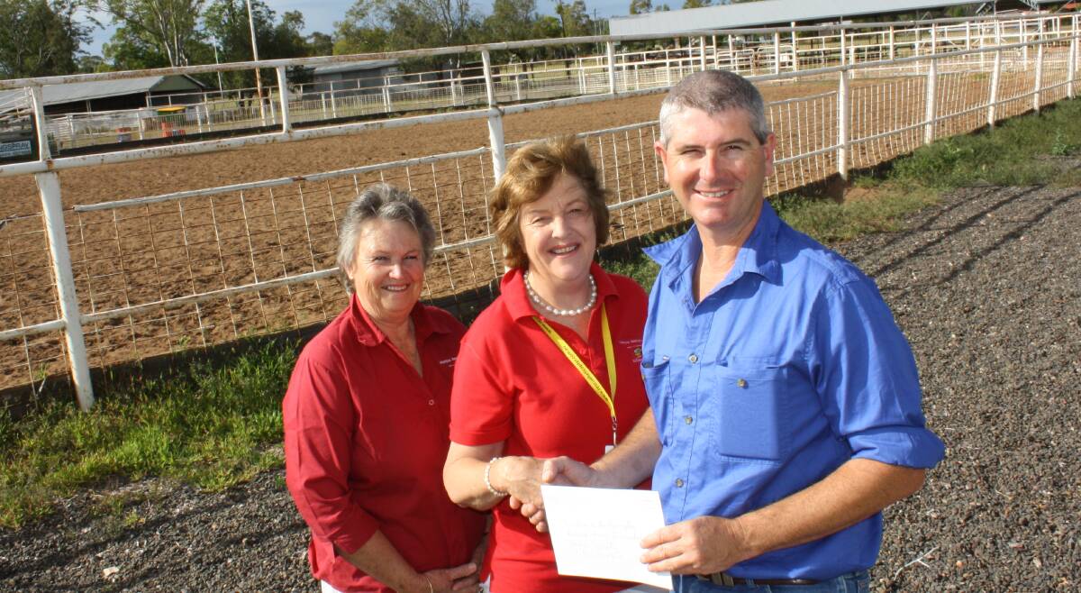 Rescue helicopter volunteers Heather Stephens and Pam Bradford accept a $1000 donation from Gunnedah Show Society's George Truman.
