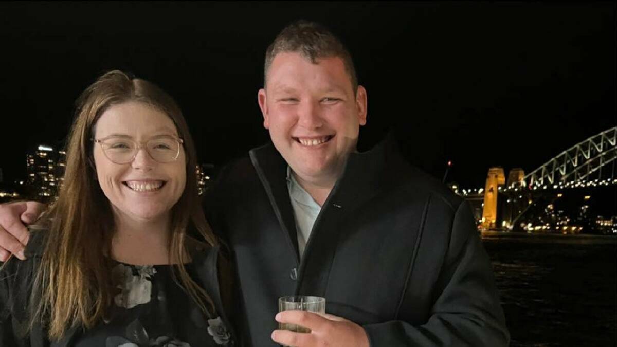 Steven Tougher and his wife, Madison, pictured at night with the Sydney Harbour Bridge in the background.