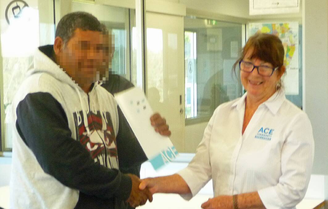 ACE Community College's Jan Levy presents a participant with his Certificate II in Aboriginal and Torres Strait Islander Cultural Art.