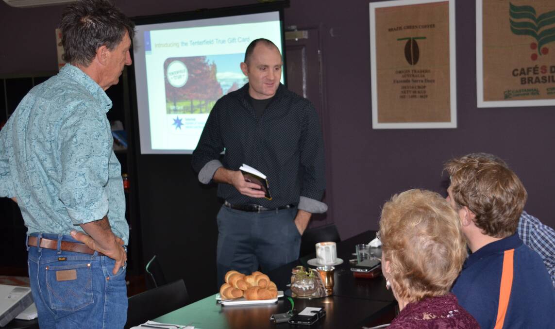 Tenterfield Chamber president Vince Sherry and Why Leave Town Promotions' Ashley Watt speaks with local business owners at the Tenterfield True gift card launch.