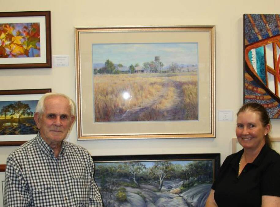 Bill Odd, winner of the 2017 Acquisition Prize of $1000 with his oil painting "Morning Tenterfield Station", with competition sponsor Kerri Swain.