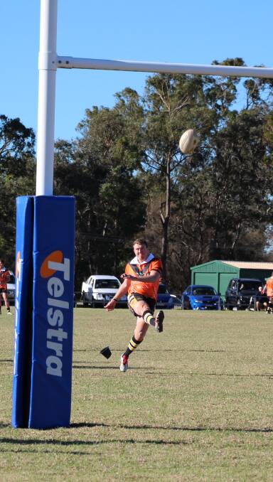 Against the wind: Brendan Minns converts a try under very challenging conditions.