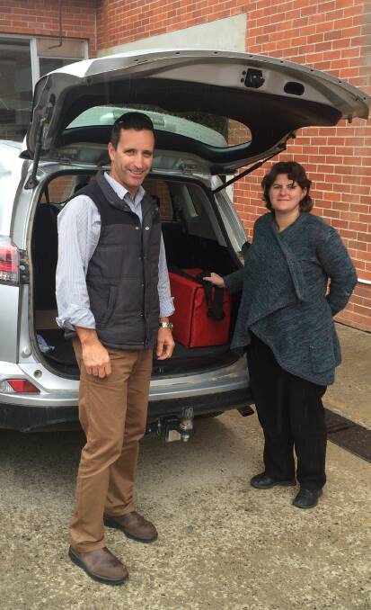Council's health and building surveyor Jamie Murphy and water and waste manager Melissa Blum pack up to deliver Meals on Wheel to local residents.
