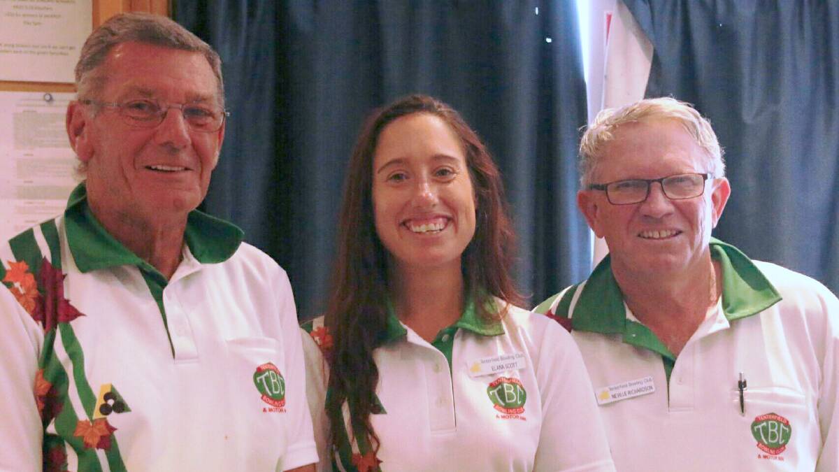 HAPPY BUT HUMBLE: Bryce Titcume presents the pairs win to Tenterfield bowlers Elana Scott and Neville Richardson.