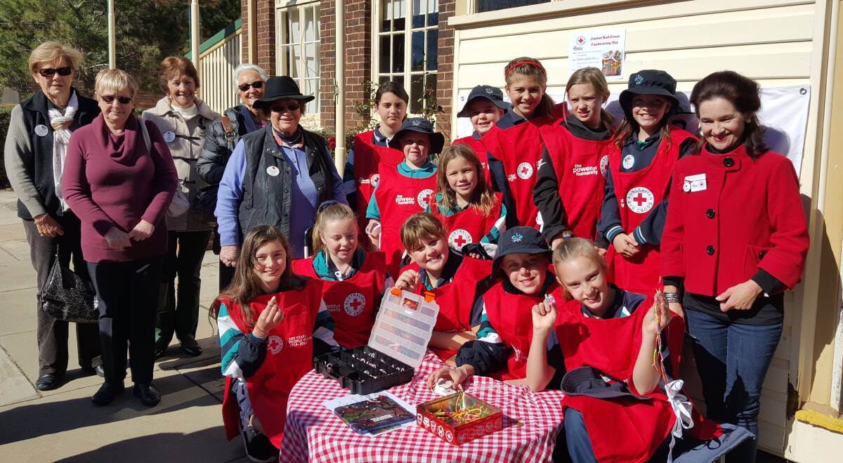 Part of the Junior Red Cross contingent at Glen Innes Public School got some support from local Red Cross members for their Donate a Dollar Day fundraiser.