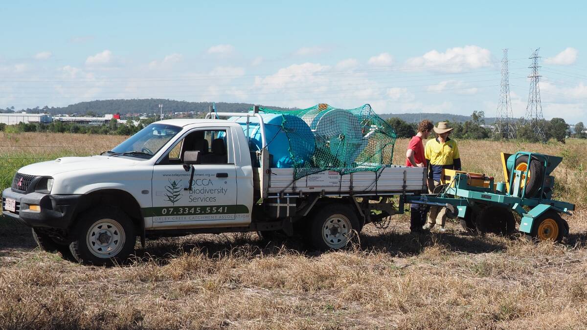 Andrew McVinish and Evan Davies assist the Oxley Creek Catchment Association to complete a direct seeding project with the Northern Tablelands Local Land Services tree seeder.