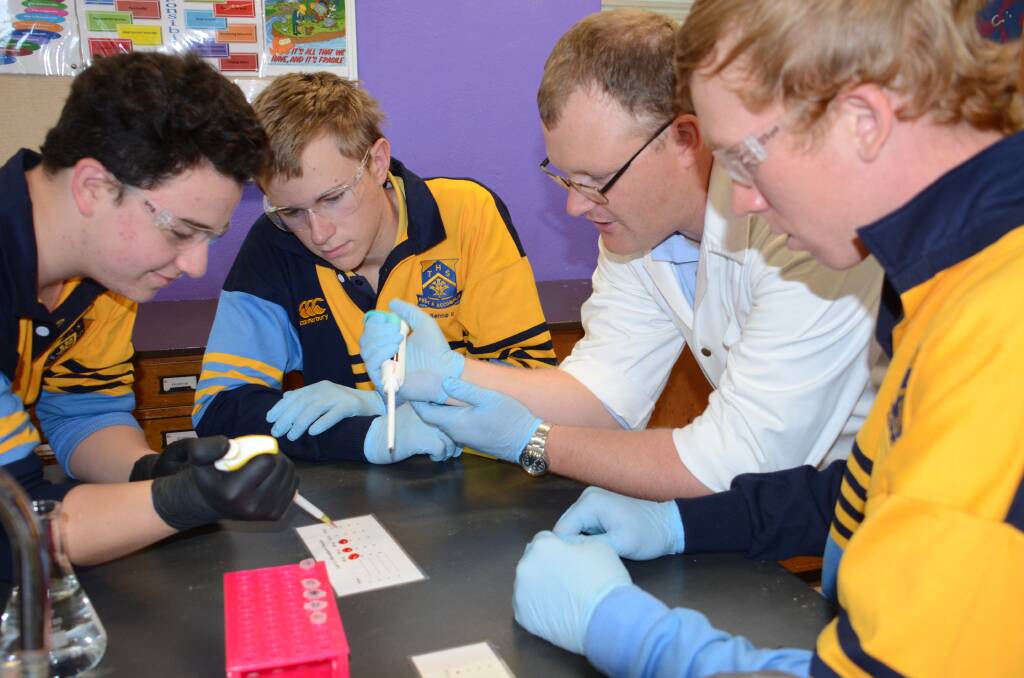 Science teach Brian Edmonds engages Year 11 biology students Kurt Frattin, Michael Benstead and Lachlan Dorward in the wonders of science.