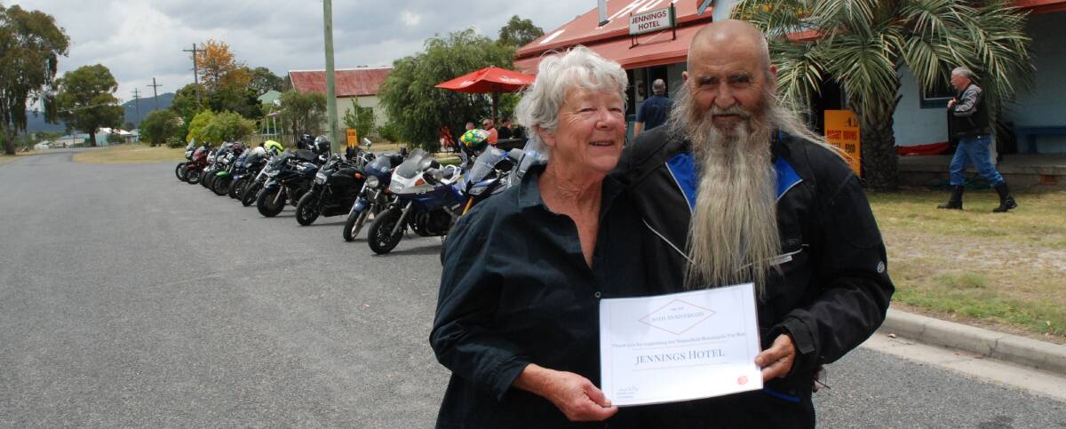 THANKS: Toy run organiser Wayne Lusty presents a certificate of appreciation to Jennings Hotel publican Lyn Schenck during the run's stopover on Saturday.
