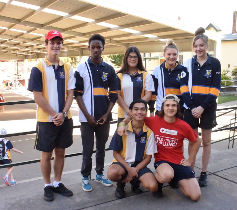(Standing, from left) Josh Gower, Ezekia Nitinga, Dina Pelusi, Sophie De Git and Katie Hickey, and (kneeling) France Dago-oc and Josh Collins are part of the high school crew ready to collect donations on March 12.