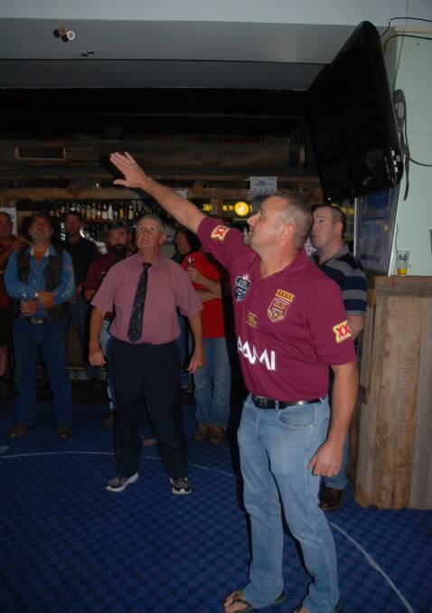 Spinner Simon McConville sends the coins into the air, as boxer John Munro watches closely.