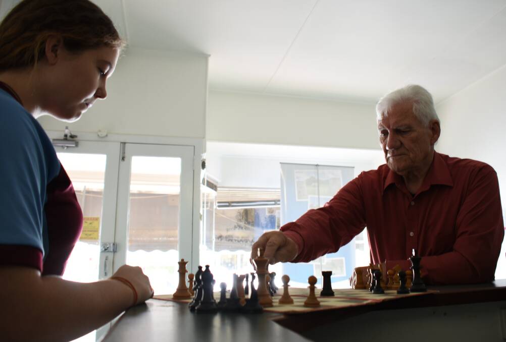 Chess expert John Lavery challenges granddaughter Claudia Collins to a game. Mr Lavery is running free chess workshops at The Hub on a Friday morning.