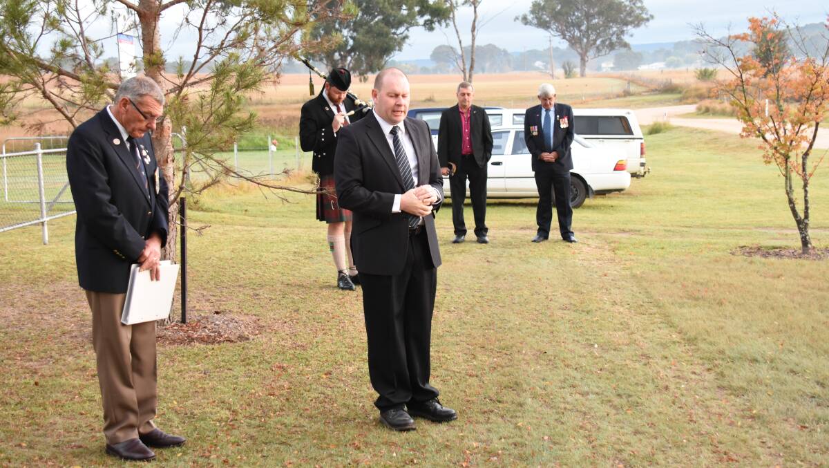 Anglican minister John Cooper leads the congregation in prayer at the Tenterfield Cemetery service.