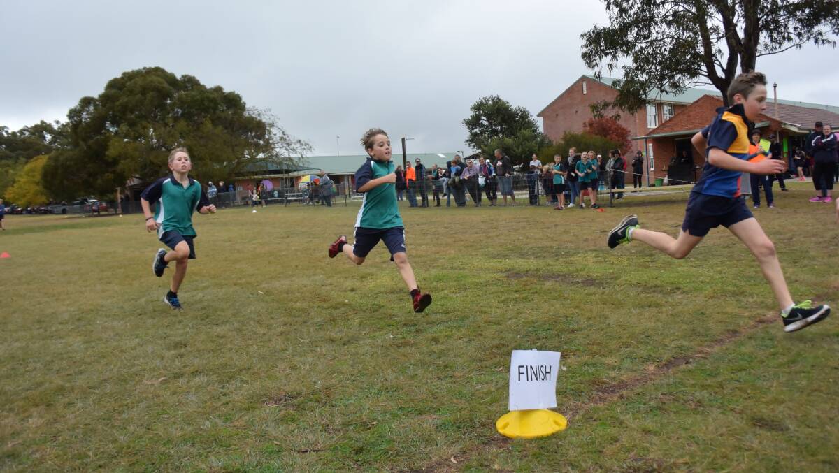 Sir Henry Parkes Memorial Public School's Tom Fowler strides out ahead of Nate Wade and Jamie Crawford of Glen Innes Public School.