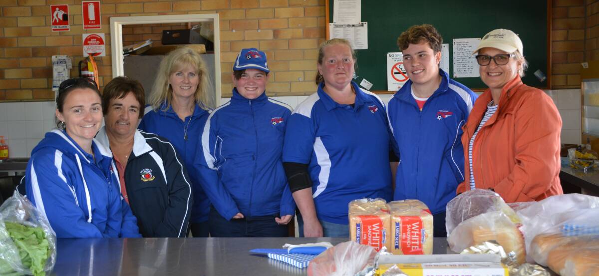 Alana and Julie Condrick, Lyn Gower, Annie-May and Anne Newman, Ellen Counter and Kim Thompson man the canteen as hosts of the Football Stanthorpe major semis.