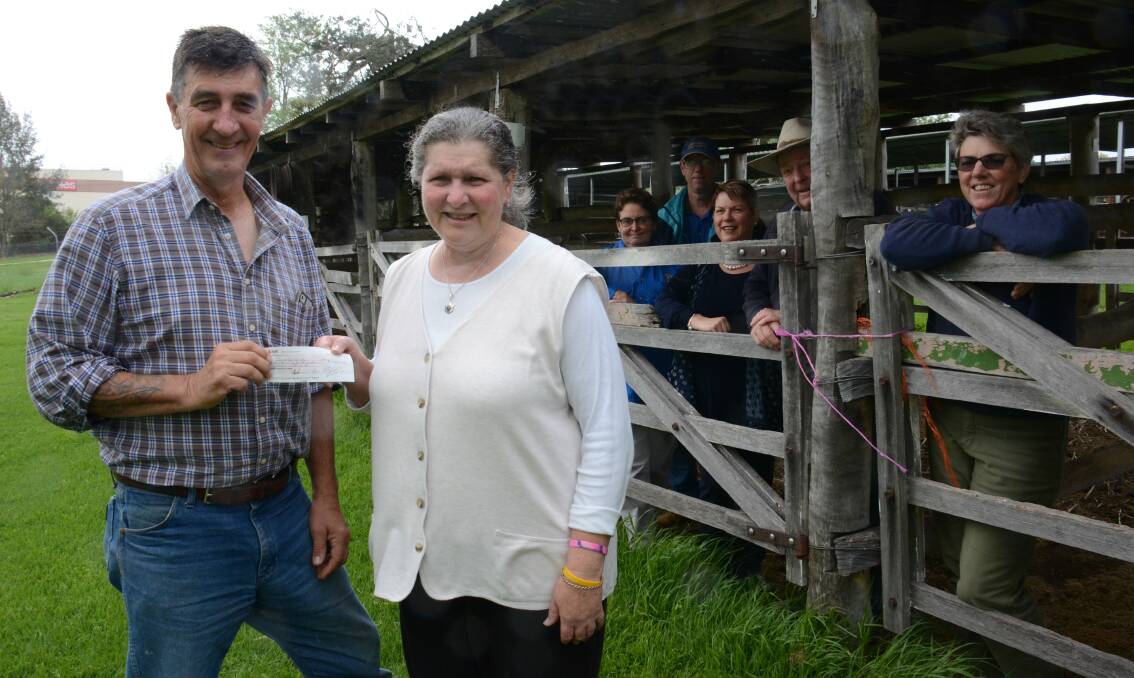 Border Country Trail Riders president Vince Sherry hands over the proceeds of the show ride to Tenterfield Show Society representative Sheryl Wright, who was also part of the catering corps. Along the back are Robyn Murray, Darrell Pacey, Kim Rhodes, Bruce Petrie and Pam O'Neill. The on-site stabling and other infrastructure made the showground and ideal base.