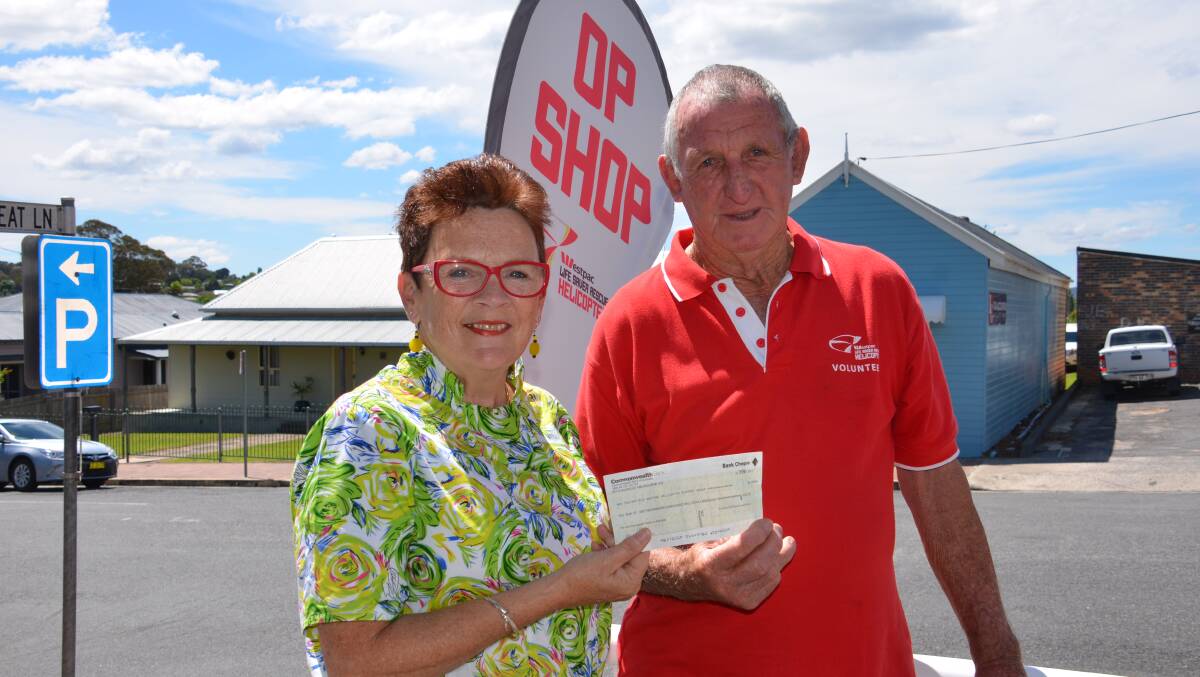 Last Matrons and Spinsters Social Group president Sandie Iedema donates the group's remaining funds to John 'Dodge' Landers of the Westpac Life Saver Rescue Helicopter Service support group.