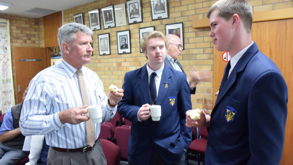 TEA AND JAM: Tenterfield High School leaders Nathan Landon-Beer and Jake Smith catch up with mayor Peter Petty during a break in the council meeting.