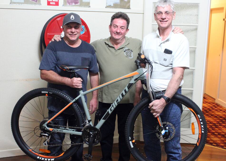 Marcel Little, Frank O’Reilly and Darryl Pederson organise the raffle of the ‘Giant Talon’ mountain bike.