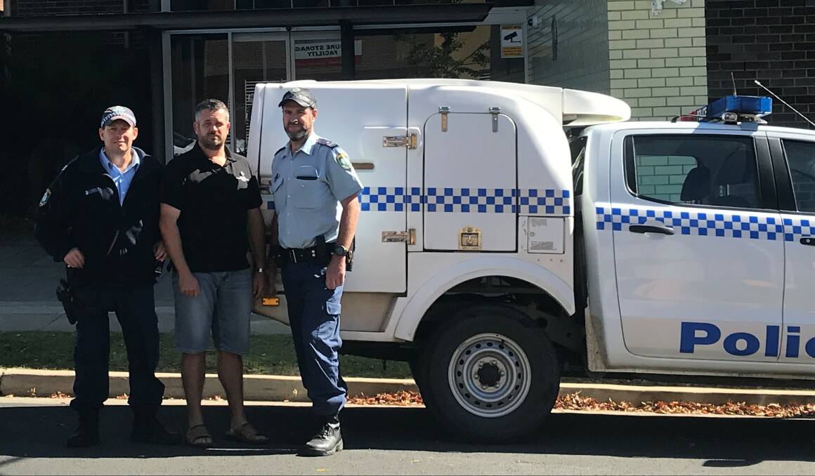 Chris Jordan flanked by Sgt Matt Scott and Sgt Simon Meehan in one of the 'ice cream trucks' used to transport prisoners.