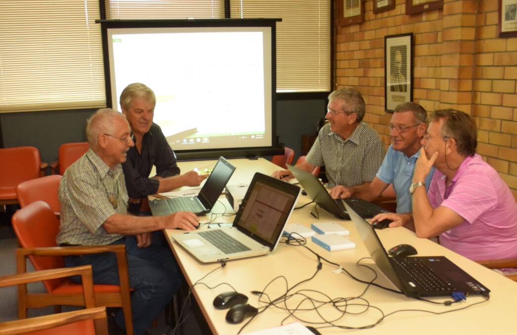 Anzac Centenary committee: (From left) Allan Williams, Peter Reid, John Brown, Don Fornes and Bryce Titcume working on the digital honour board.