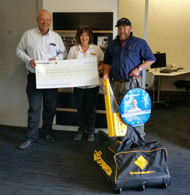 HOWZAT? Tenterfield's Royals Cricket Club represented by Alan Donges (on left) and David Fowler received gear and cash from local Commonwealth Bank representative Deborah Minns.