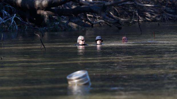 Divers search for the five-year-old boy who was later found dead in the river. Photo: Luke Hemer