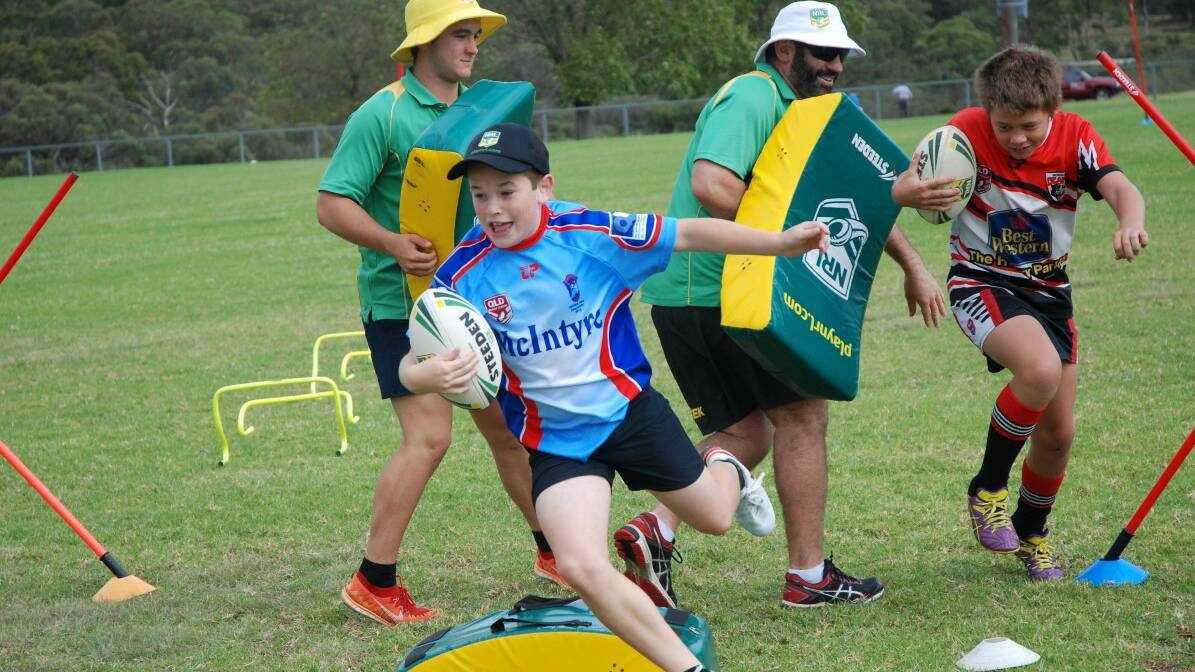 Braith Clarke and Darcy Roots brave the obstacles set by QRL coaches Zac Stevens and Scott Morton.