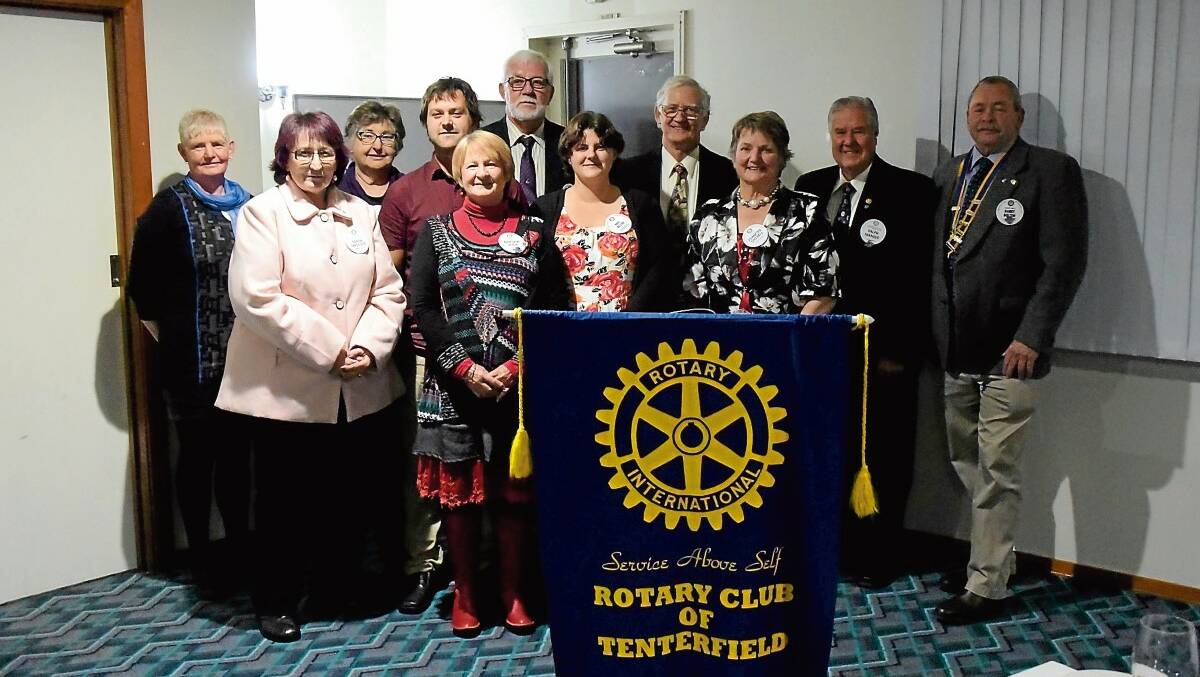 STANDING UP FOR THE COMMUNITY: (Back row) The new Tenterfield Rotary Club board was introduced and new president Harry Bolton (far right) installed at the the club’s changeover dinner on June 28.