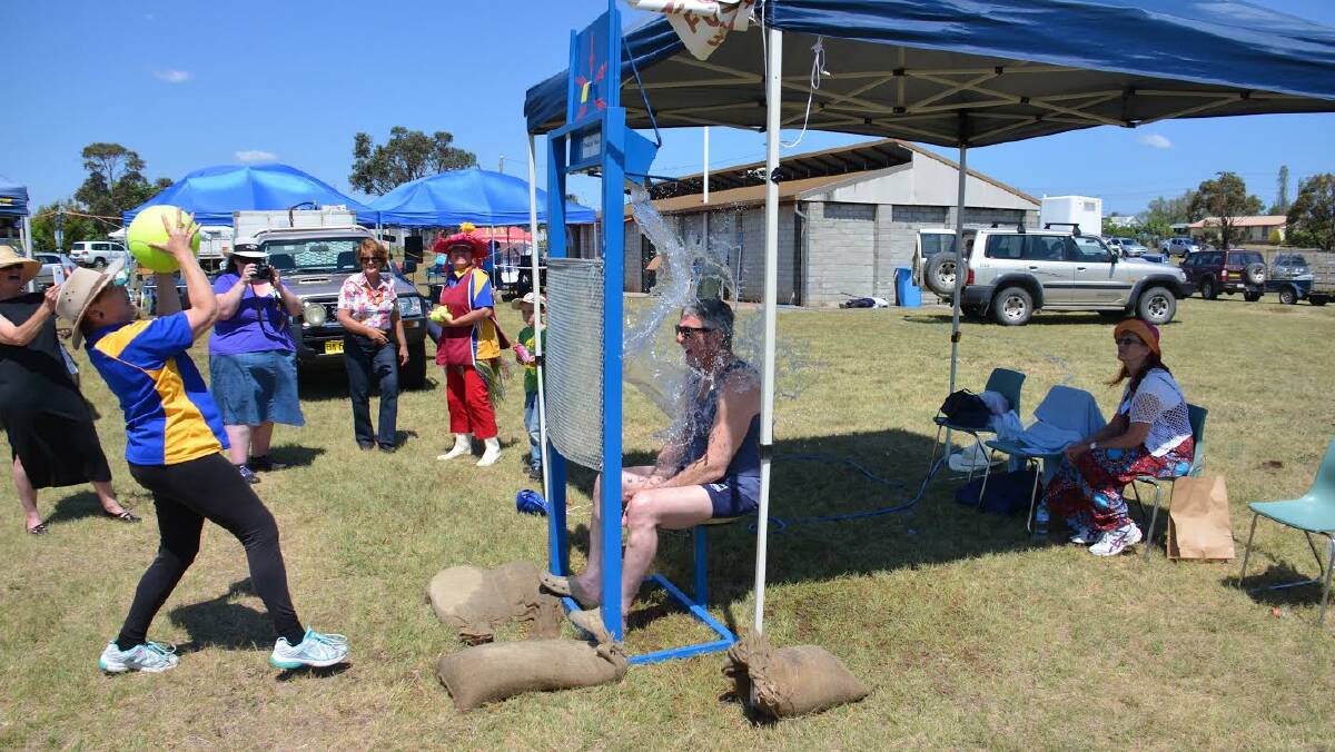 ON TARGET: Tenterfield Shire mayor Peter Petty gets a soaking in the Dunk-a-Pollie at this year’s Deepwater Scarecrow and Wool Festival.