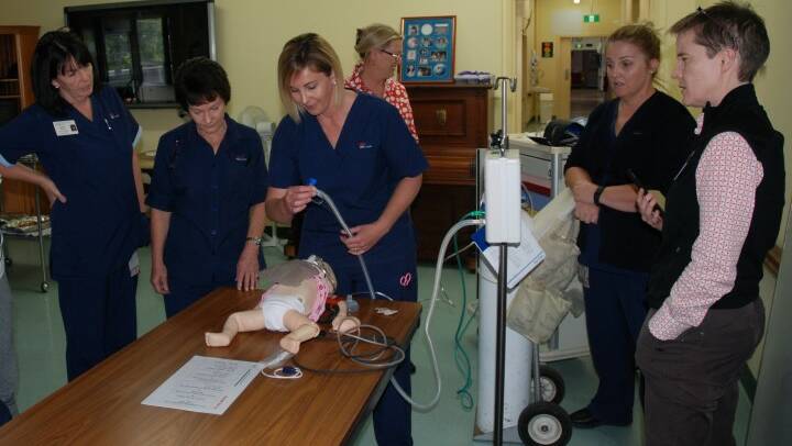 PREPARED: Tenterfield Hospital nursing staff (from left) Norma Rhodes, Elaine Montague, Stacey Butler and Kimberley Druitt get in some hands-on practice under the supervision of paediatric clinical nurse consultant Helen Stevens (at back) and EMET trainer Dr Liz Jones.