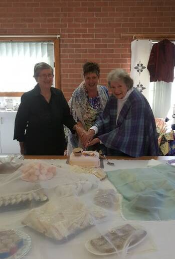 50 YEARS: Society patron Edith Campbell, president Fran Bulmer and past member Barbara Fraser cut the celebration cake.