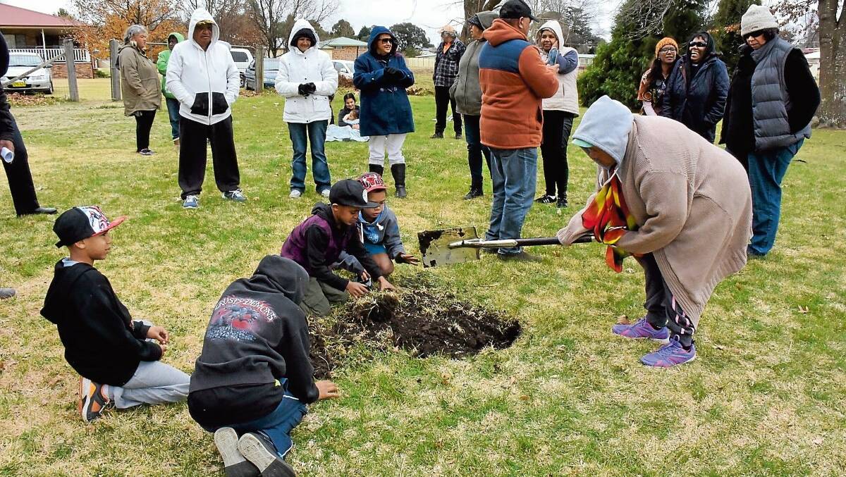 COMMUNITY HEALING: Clinton Duroux's stepmother Marjory Jarrett takes her turn breaking ground for a gazebo to be constructed in Millbrook Park in memory of the murdered 16-year-old.