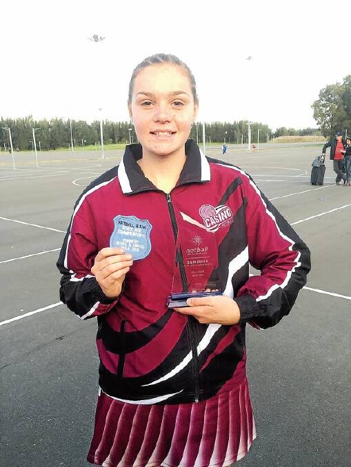 FEELING PROUD: Lexi Taylor with her patch and team trophy.