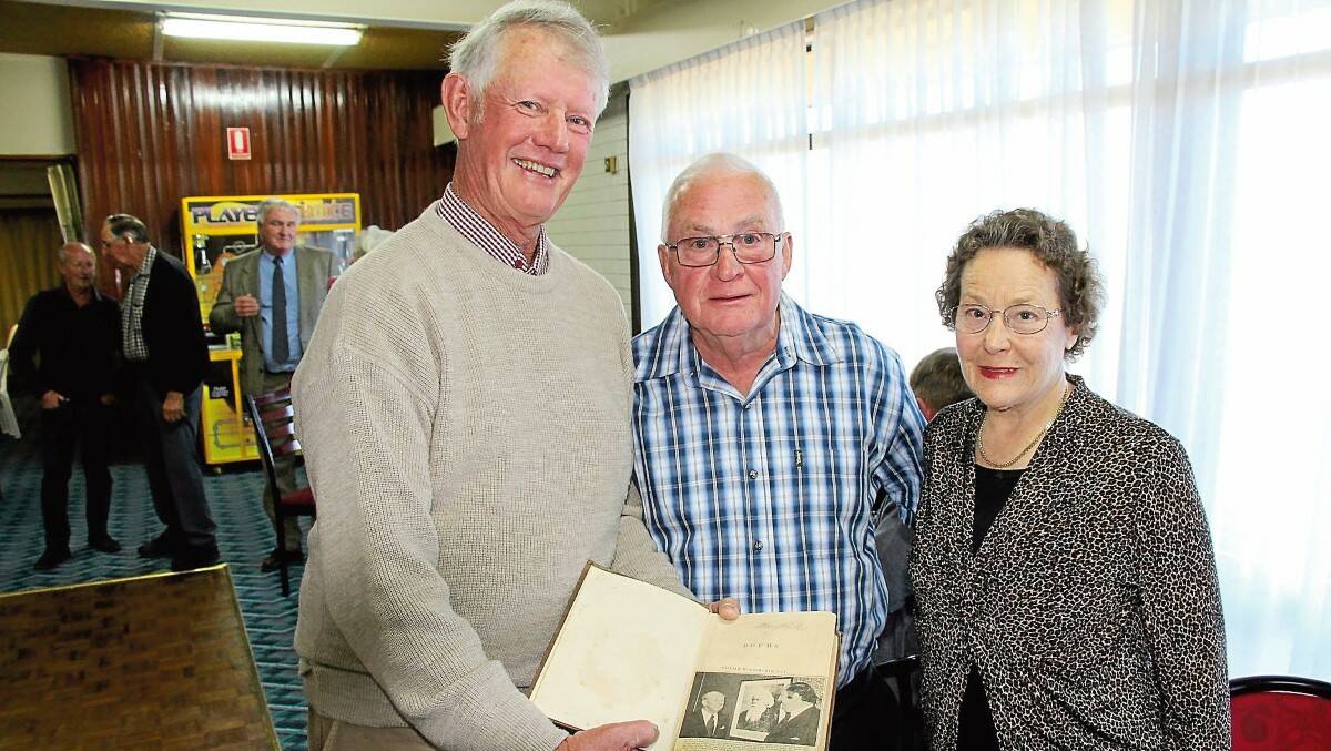 Friends of Sir Henry Parkes School of the Arts’ Peter Jeffrey along with Loraine and Robert Tumbridge admires the book of Wordsworth poetry signed by Parkes, donated to the Sir Henry Parkes Museum by Roger Braham.
