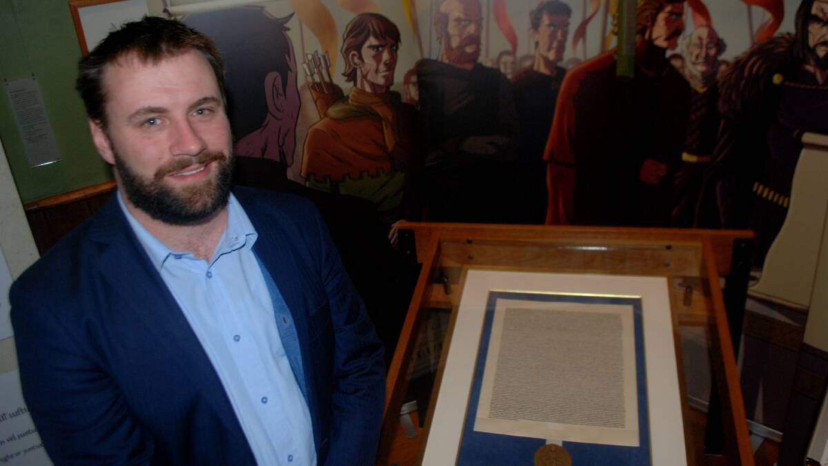 Rule of Law Institute of Australia Chief Executive Officer Nick Clark with the replica Magna Carta on display at the School of Arts. 