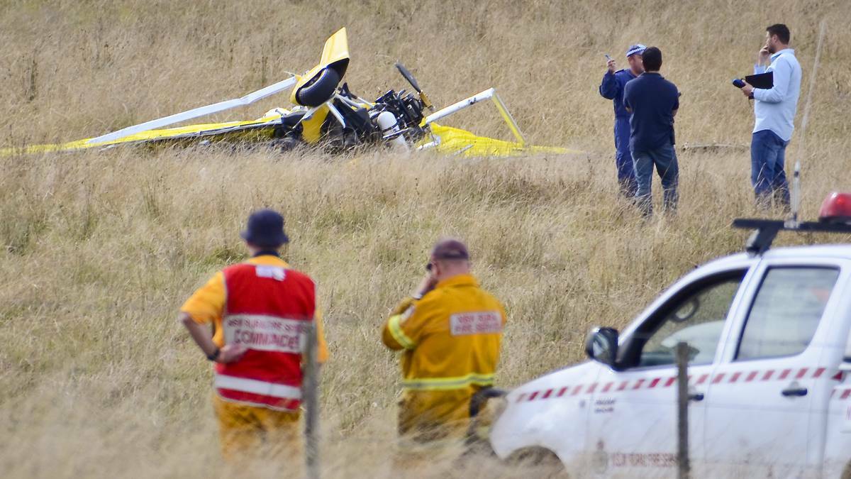Investigators comb the scene following the microlight crash at a Dundee property south of Tenterfield.