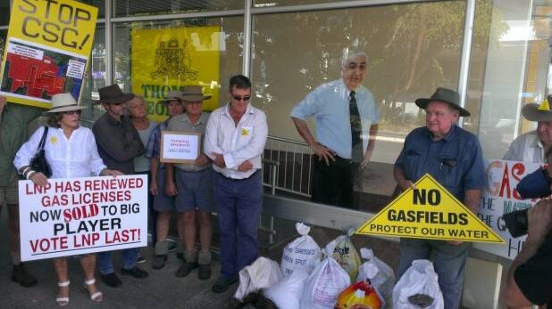 Anti-CSG protesters outside Thomas George's Lismore office this morning. The group dumped bags of manure outside the office in a frank display against Mr George's gas mining stance. Photo courtesy of The Sydney Morning Herald.