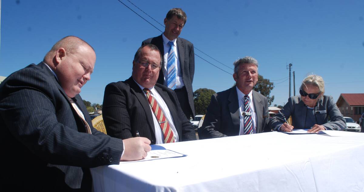 Former cross border commissioner Steve Toms (standing) was present for the signing of a memorandum of understanding between Tenterfield and Southern Downs councils.