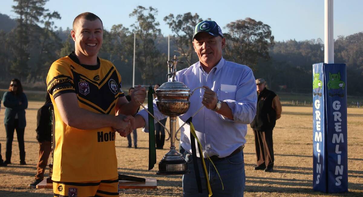 Brendan Minns is presented with the Caldwell Cup Trophy by Norm Crisp. Despite the loss on the weekend the cup is presented to the winner of the best out of three games between the two clubs.