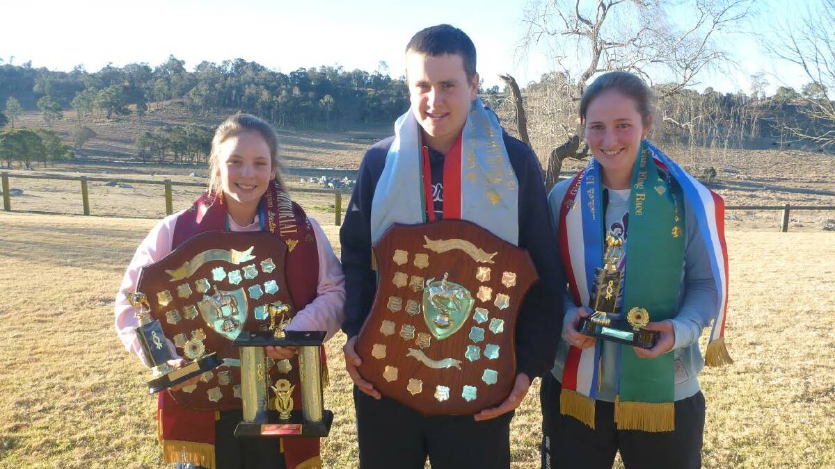 Chloe Butler, Jackson Kings and Emily Butler show off their haul of trophies from the Glowalman Championships.  