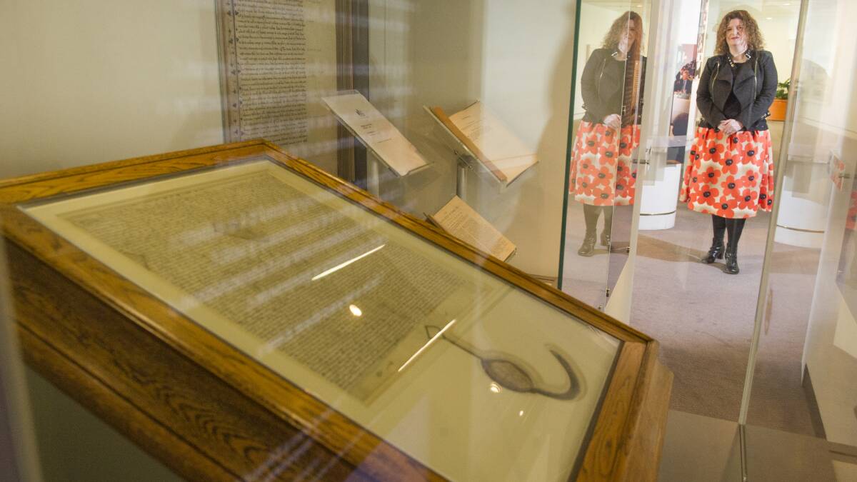 Director of the Parliamentary Art Collection Justine van Mourik with a Magna Carta that is on display at Parliament House. Tenterfield Shire Council have secured a copy of the Magna Carta from Canberra Law Courts to exhibit from July 6. 