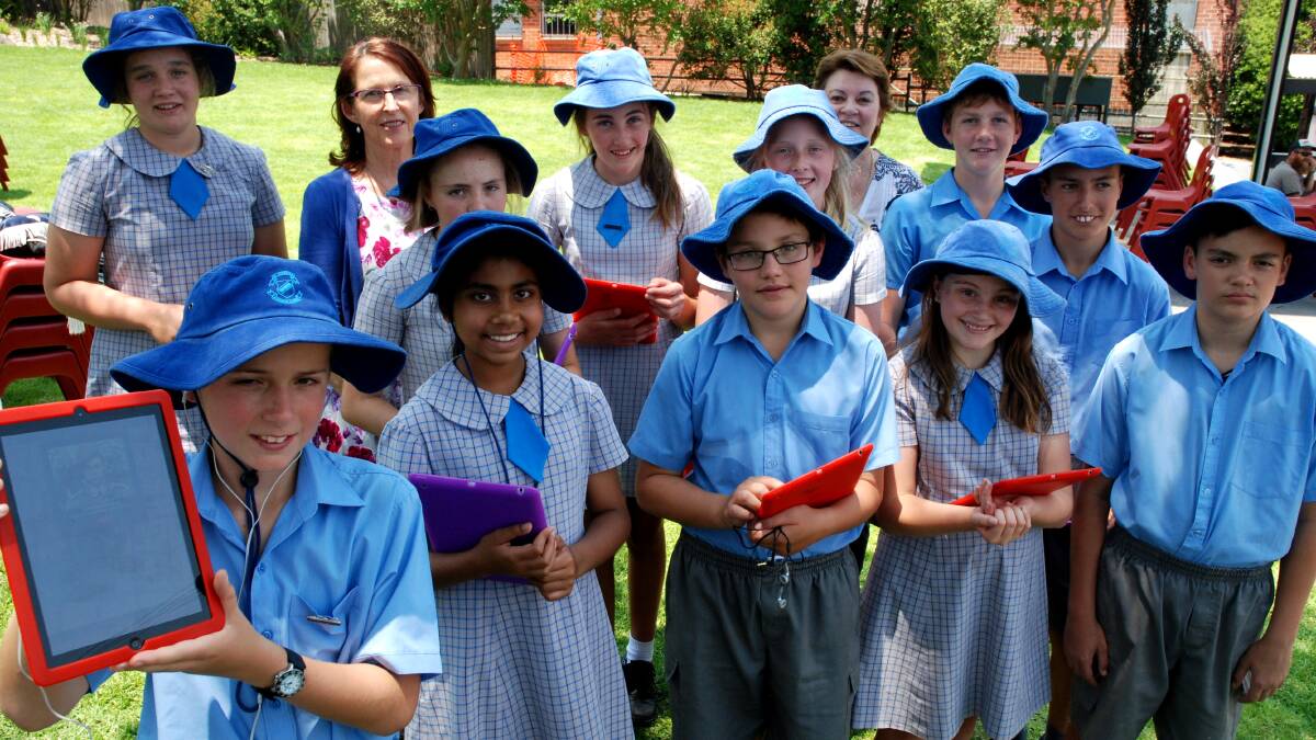 TECH HEADS: St Joseph’s students with school principal Cherie Yates and teacher Megan Flynn used Bruxner Park on Thursday to launch their finalised Soundtrails phone App. 