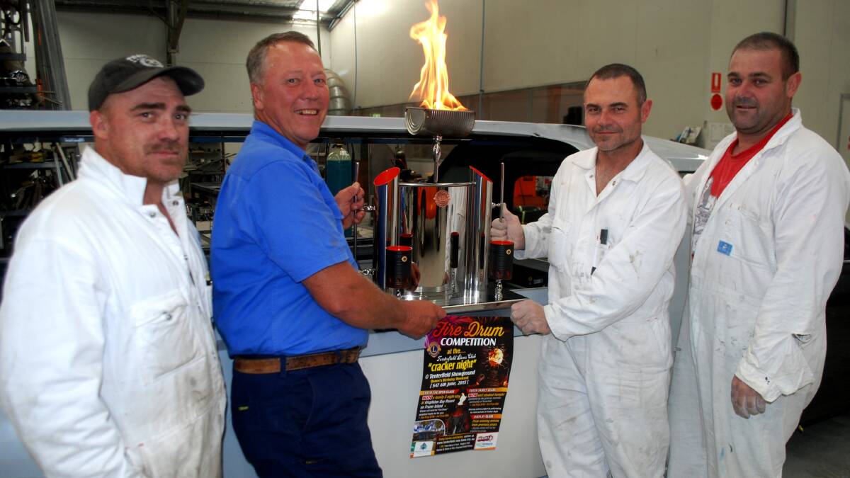 Clint Cross, Rod Stanford and Clayton and Troy Hillier with the fire drum competition trophy. 