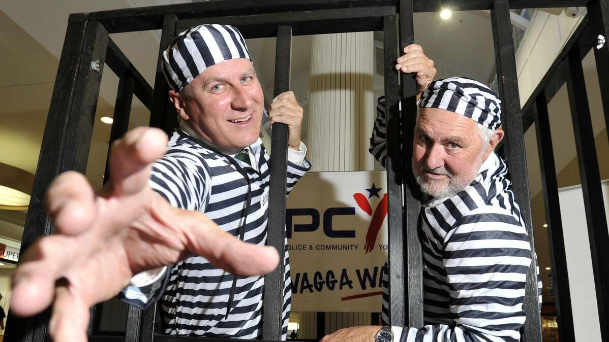 Member for Riverina Michael McCormack and mayor Rod Kendall did time behind bars to raise money for the PCYC yesterday. Picture: Les Smith - The Daily Advertiser.