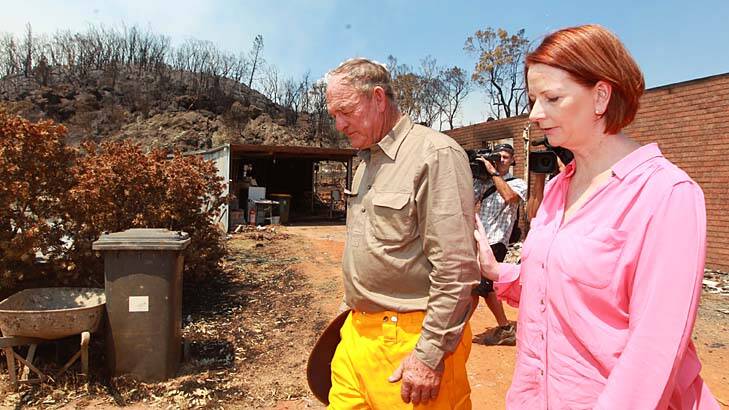 Loss … Bob Fenwick, whose home near Coonabarabran was gutted, shows the Prime Minister his property on Thursday.