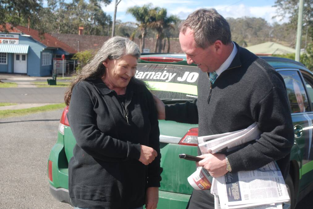Senator Barnaby Joyce on the campaign trail in Woodenbong, discussing the Mt Lindesay road with mail woman Ann Whitfield. photo: Matthew Purcell.