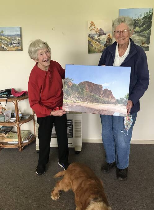 A GENEROUS DONATION: Annette Woolnough presenting one of her paintings to RSPCA Tenterfield Support Group representative Norma Ovenden. PHOTO: Supplied